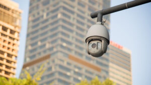 Outdoor CCTV dome camera installed on a pole against a city skyline, illustrating CCTV installation in Qatar